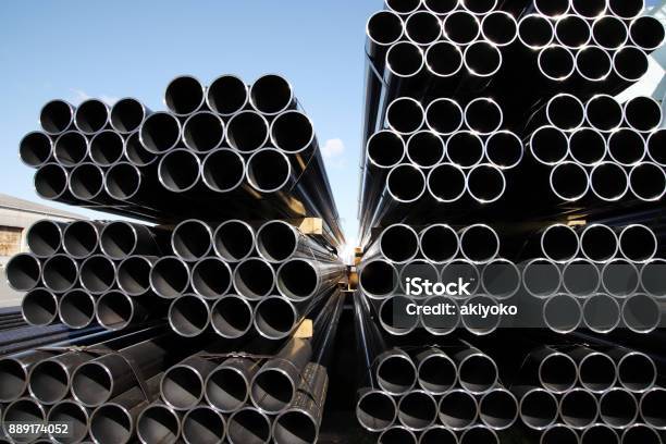 Stack Of Steel Tubes Against Blue Sky Stock Photo - Download Image Now - Steel, Pipe - Tube, Tube