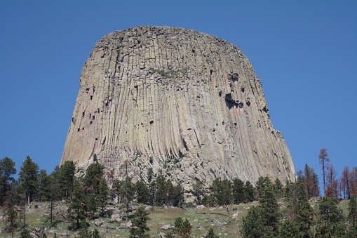 Devils tower on sunny day with blue sky, Wyoming, USA.