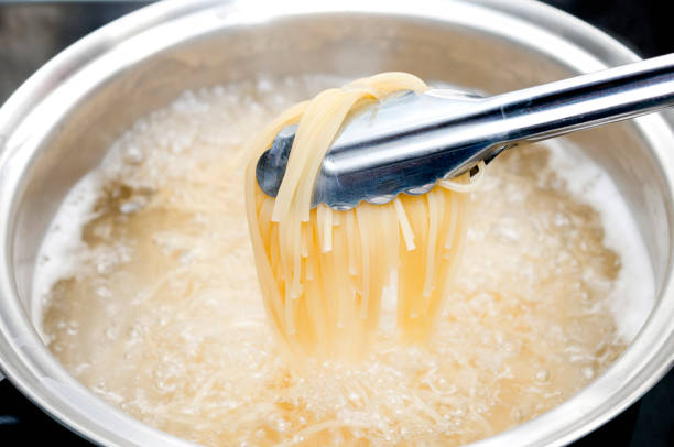 istock Boiling spaghetti in a stainless steel pot 889192788