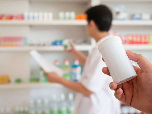 istock blur pharmacist taking medicine from shelf in the pharmacy 889195882