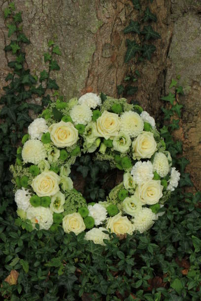 istock white sympathy wreath near a tree 889196018