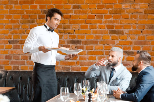 cameriere che serve agli uomini d'affari nel ristorante - restaurant waiter table wait staff foto e immagini stock