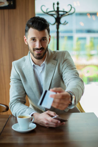 istock Busninessman paying bill by card 889223488