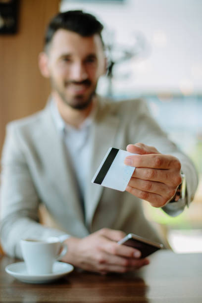 istock Busninessman paying bill by card 889225738