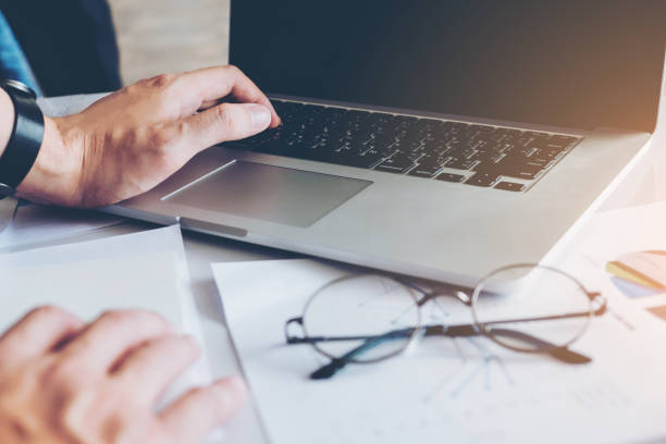 istock Business man Using Laptop with Report chart in office planning new business project 889226028