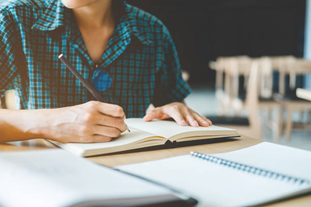istock High school or college student studying and reading in library 889226130
