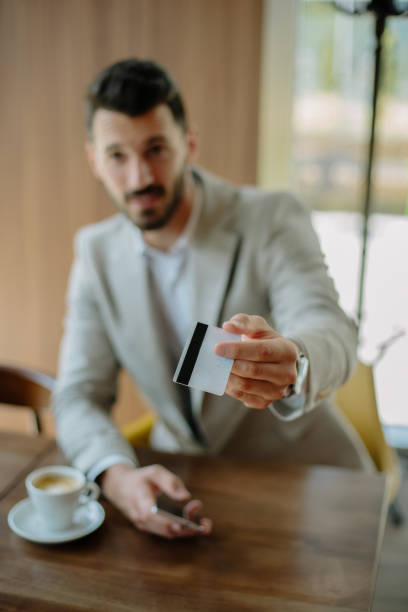 istock Busninessman paying bill by card 889228330