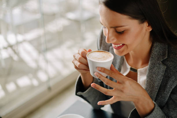 istock Young woman drinking coffee in cafe bar 889258128