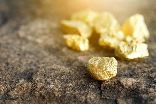 istock The pure gold ore found in the mine on a stone floor 889264928