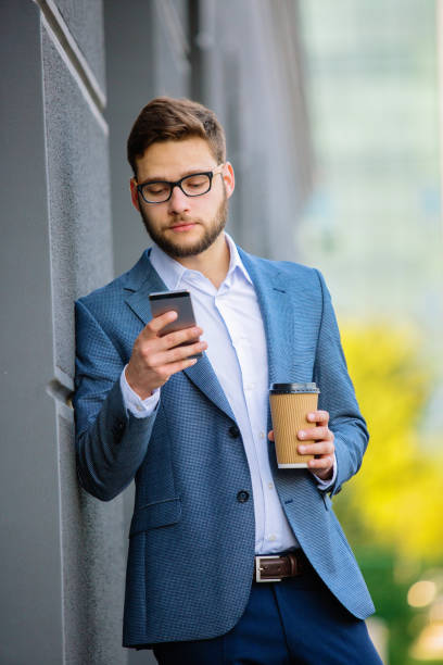 istock Young businessman typing message outdoors 889296746
