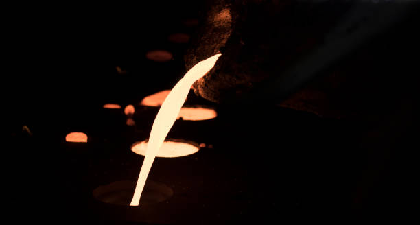 istock pouring molten metal into sand mold 889299832
