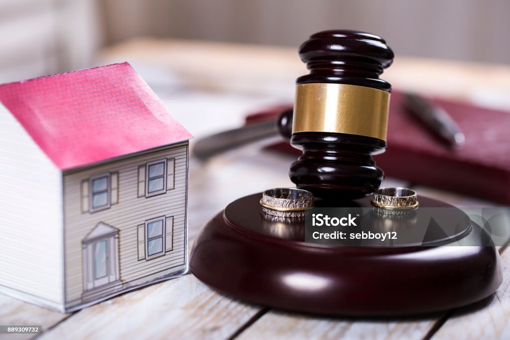Family law concept. Divorce. Gavel, house and rings Calculator Stock Photo