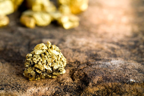 istock The pure gold ore found in the mine on a stone floor 889312612