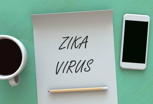 istock Zika Virus, message on paper, smart phone and coffee on table 889312754