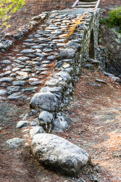 The last rays of the setting sun illuminated the ancient stone arch Venetian bridge in the Central part of Troodos mountain.