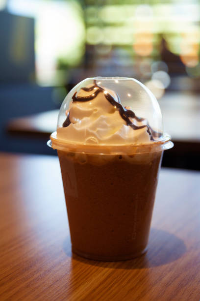 Chocolate milkshake with whipped cream on table