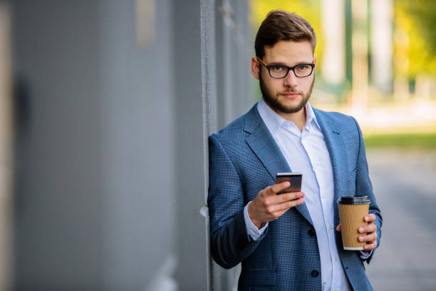 istock Young businessman having phone call outdoors 889318108
