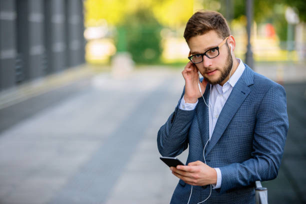 istock Young businessman having phone call outdoors 889320414