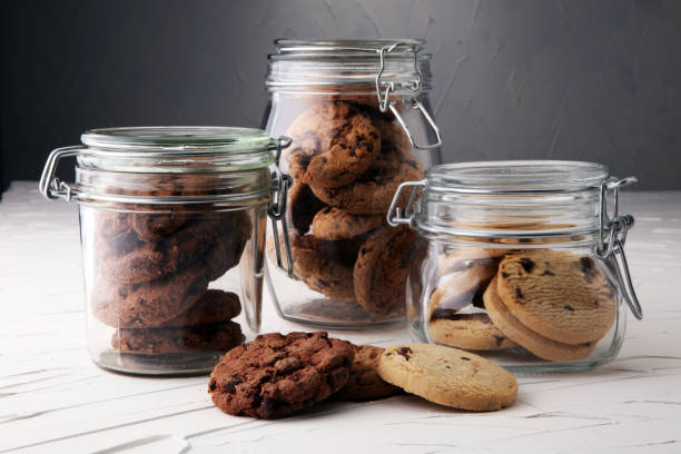 istock Chocolate cookies in a glass jar on white background 889323588