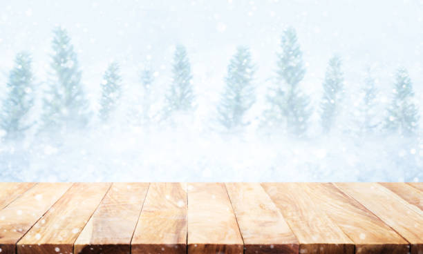 istock Wood table top on blurred snowfall in winter season background. 889353890