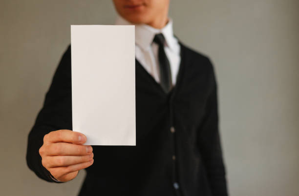 istock Business man showing blank white flyer brochure booklet. Leaflet presentation. Pamphlet hold hands. Man show clear offset paper. Sheet template. Booklet design sheet display read first person 889362382
