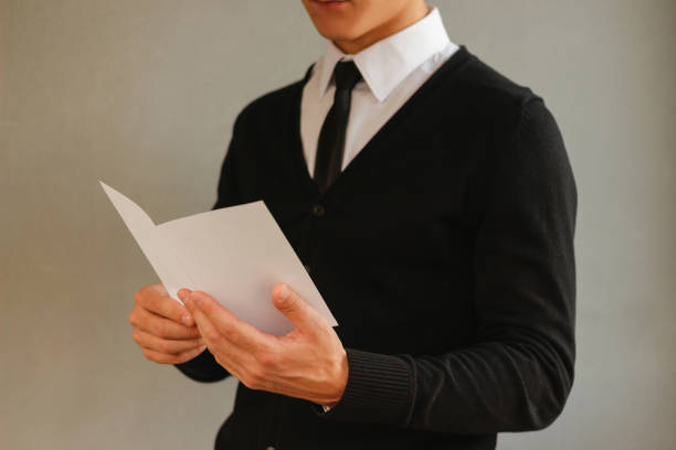 istock Business man showing blank white flyer brochure booklet. Leaflet presentation. Pamphlet hold hands. Man show clear offset paper. Sheet template. Booklet design sheet display read first person 889362384