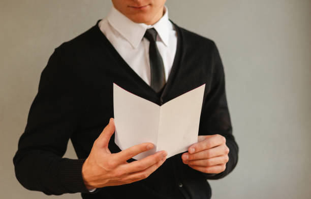 istock Business man showing blank white flyer brochure booklet. Leaflet presentation. Pamphlet hold hands. Man show clear offset paper. Sheet template. Booklet design sheet display read first person 889362388