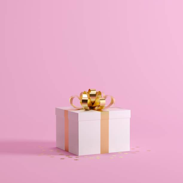 istock White Gift box with gold ribbon on Pink background for copy space. Christmas minimal concept idea. 889364546