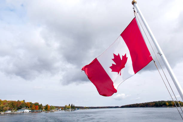 istock Canada flag waving nearby the sea 889373192