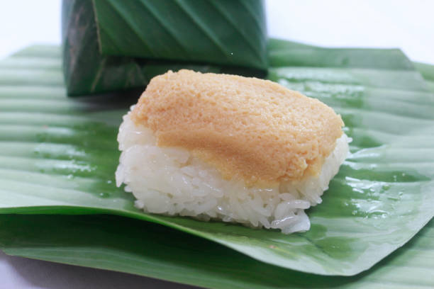 istock stick rice  with custard egg on top and warp with banana leaf. 889380860
