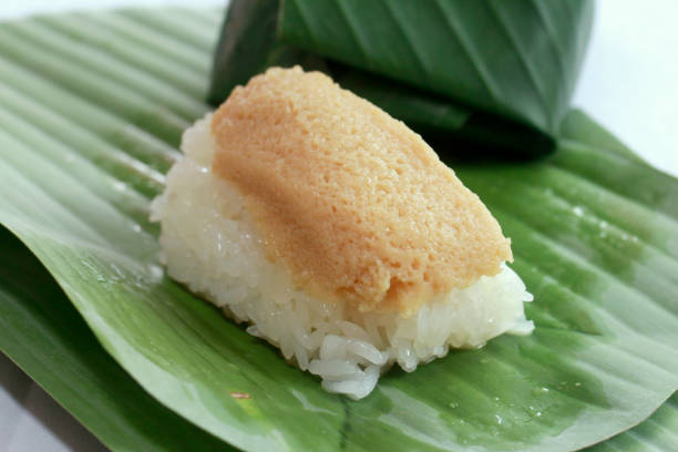 istock stick rice  with custard egg on top and warp with banana leaf. 889380884