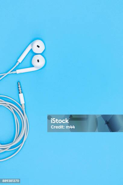 Top View Of White Earphones On Blue Plastic Texture Background Pastel Color Concept Minimal Concept Copy Space Music Is My Life Concept Stock Photo - Download Image Now