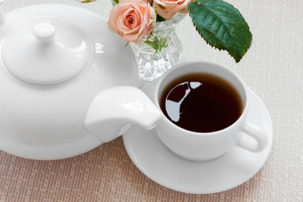 istock teapot, cup, and  roses on a plat 889395916