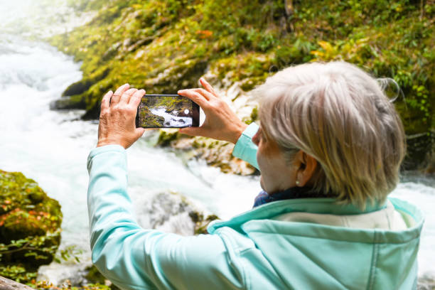 istock Attractive elderly woman taking photos and selfies 889399232
