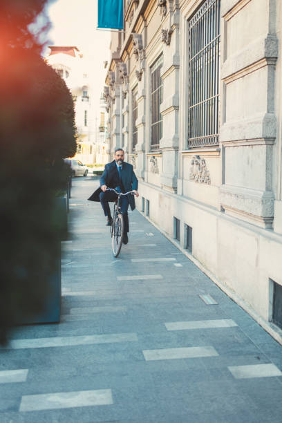 istock Businessman going on or off to work on bicycle 889408760
