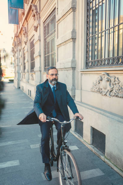 istock Businessman going on or off to work on bicycle 889408928