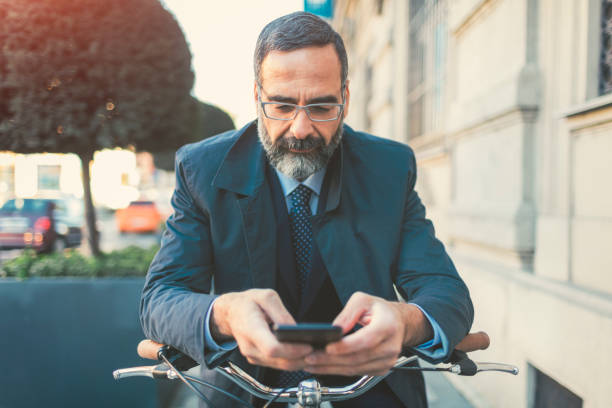 istock Businessman going on or off to work on bicycle 889408978