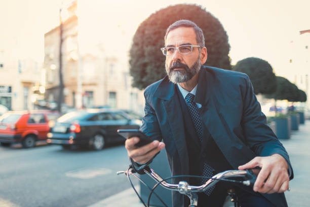 istock Businessman going on or off to work on bicycle 889409064