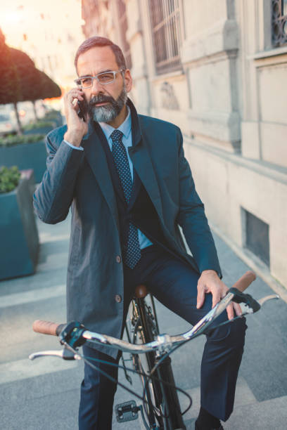 istock Businessman going on or off to work on bicycle 889417808