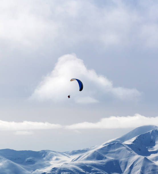 istock Sky gliding in winter snowy mountain at nice sun evening 889418052