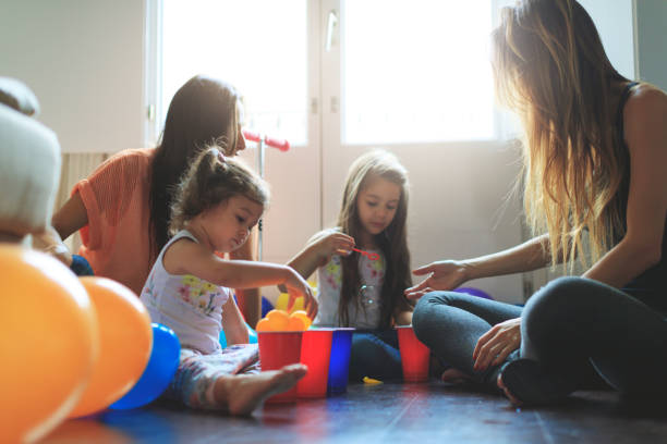 istock Mothers and daughters having fun at home 889418132