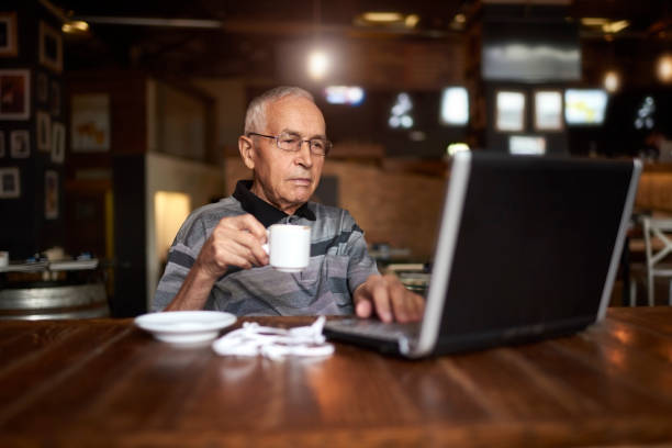 istock Senior man in coffee shop 889421098