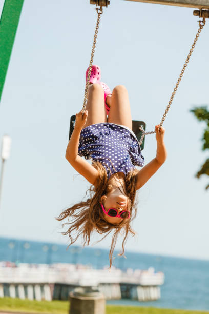 istock Playful crazy girl on swing. 889421596