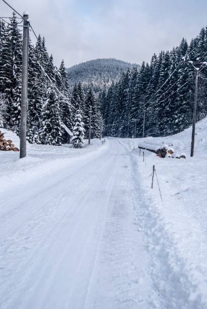 istock winter landscape with snow covered road, forest and hill on the background 889421606