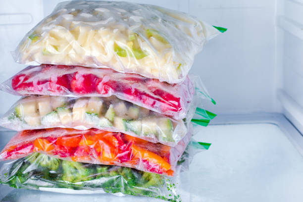 istock Bags with frozen vegetables in refrigerator, closeup 889421662