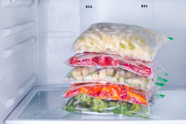 istock Frozen vegetables in bags in refrigerator 889421684