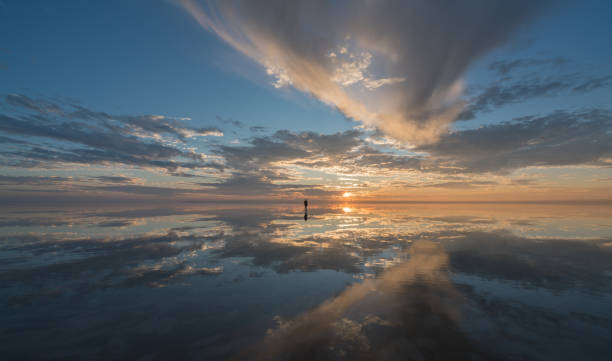 istock Young women  walking over sunset clouds  on salt lake 889421840