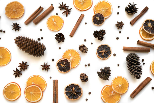 istock Christmas composition. Winter pattern made of different kinds of spices, pine cones, new year decorations, cinnamon sticks, anise stars, oranges isolated on white background. Holiday top view flat lay 889424636
