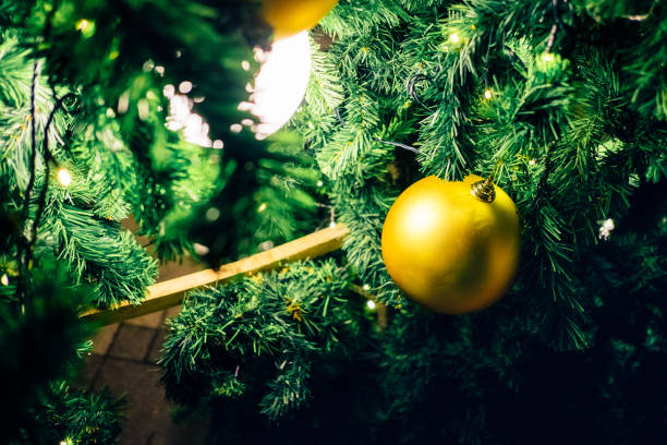 istock Golden ball ornaments hanging on Christmas Tree 889440884