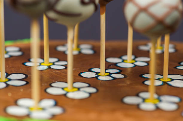 istock Cake pop sticks on home made daisy wooden plate 889441572
